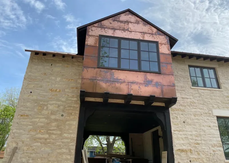 Copper metal panel facade on a stone building for Skylight Installation in Orland